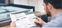 Person reviewing direct mail layouts